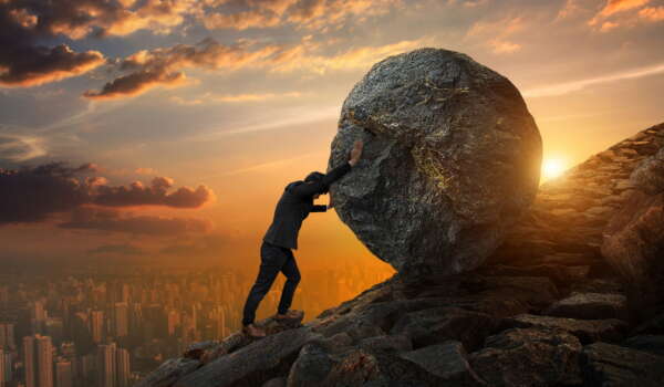 Business man pushing large stone up to hill , Business heavy tasks and problems concept.