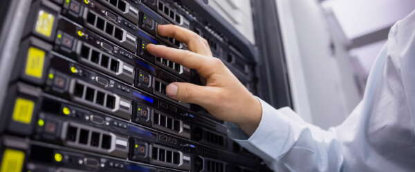 Technician working on server tower in large data center